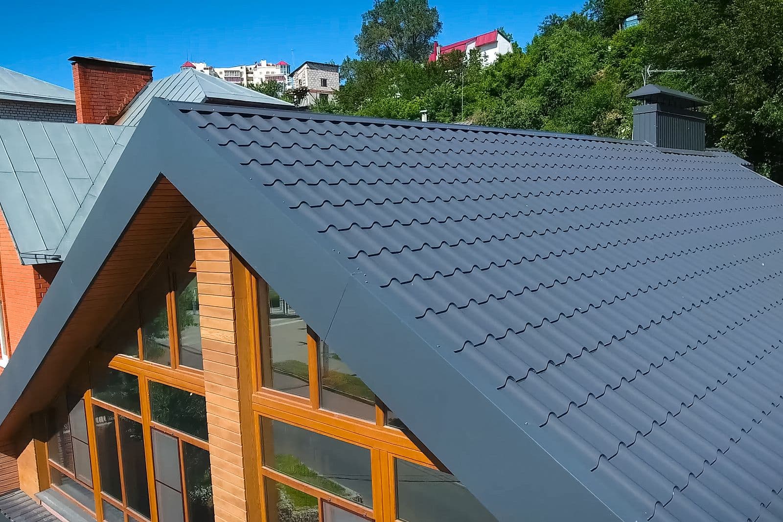 bigstock-House-With-A-Gray-Metal-Roof-A-335143726.jpg